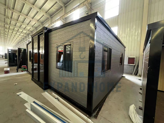 Modular building components in a warehouse setting with branding visible.