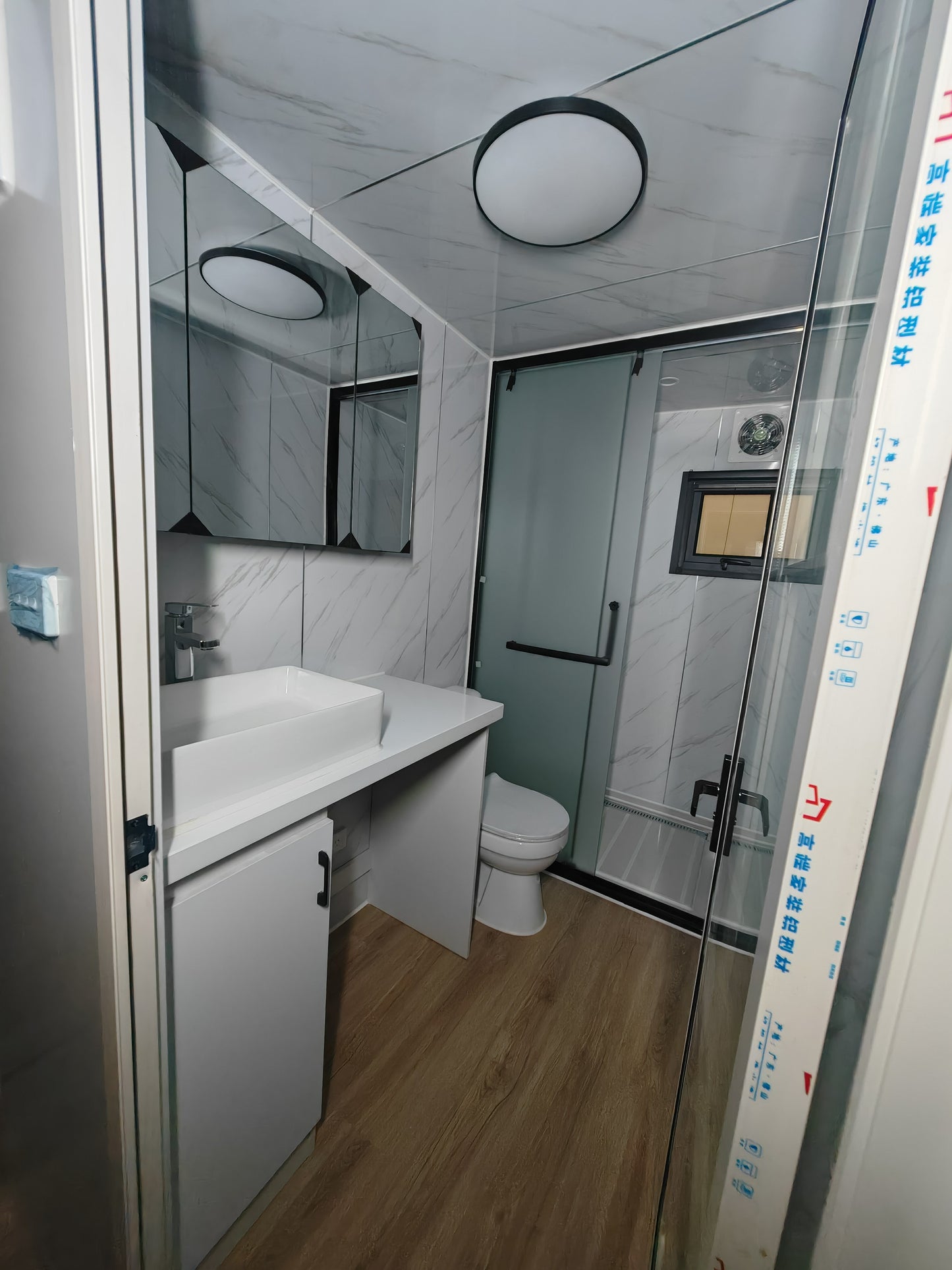 Bathroom interior with sink, toilet, and shower area.