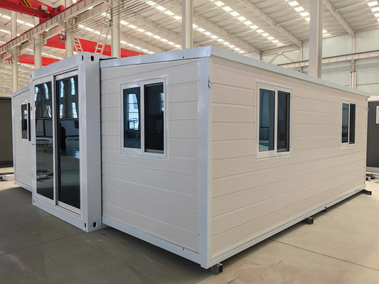 Modular building with beige exterior and white trim in a warehouse setting