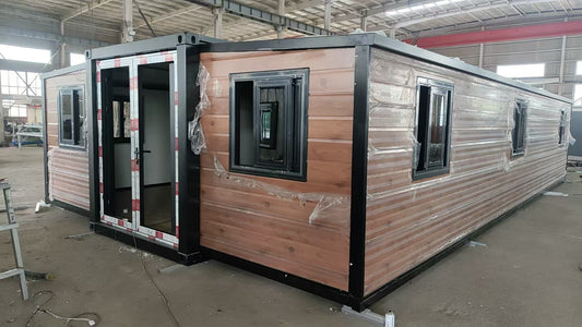 Modular building with wooden exterior and glass windows in a warehouse setting ExpandiHome