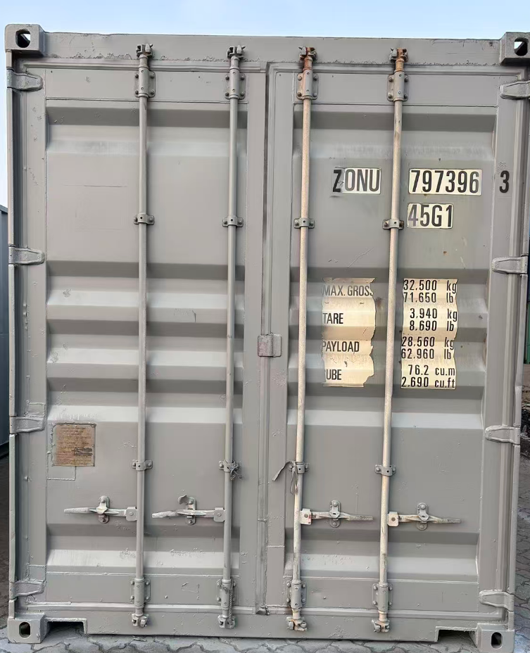 Gray shipping container with visible markings and labels.