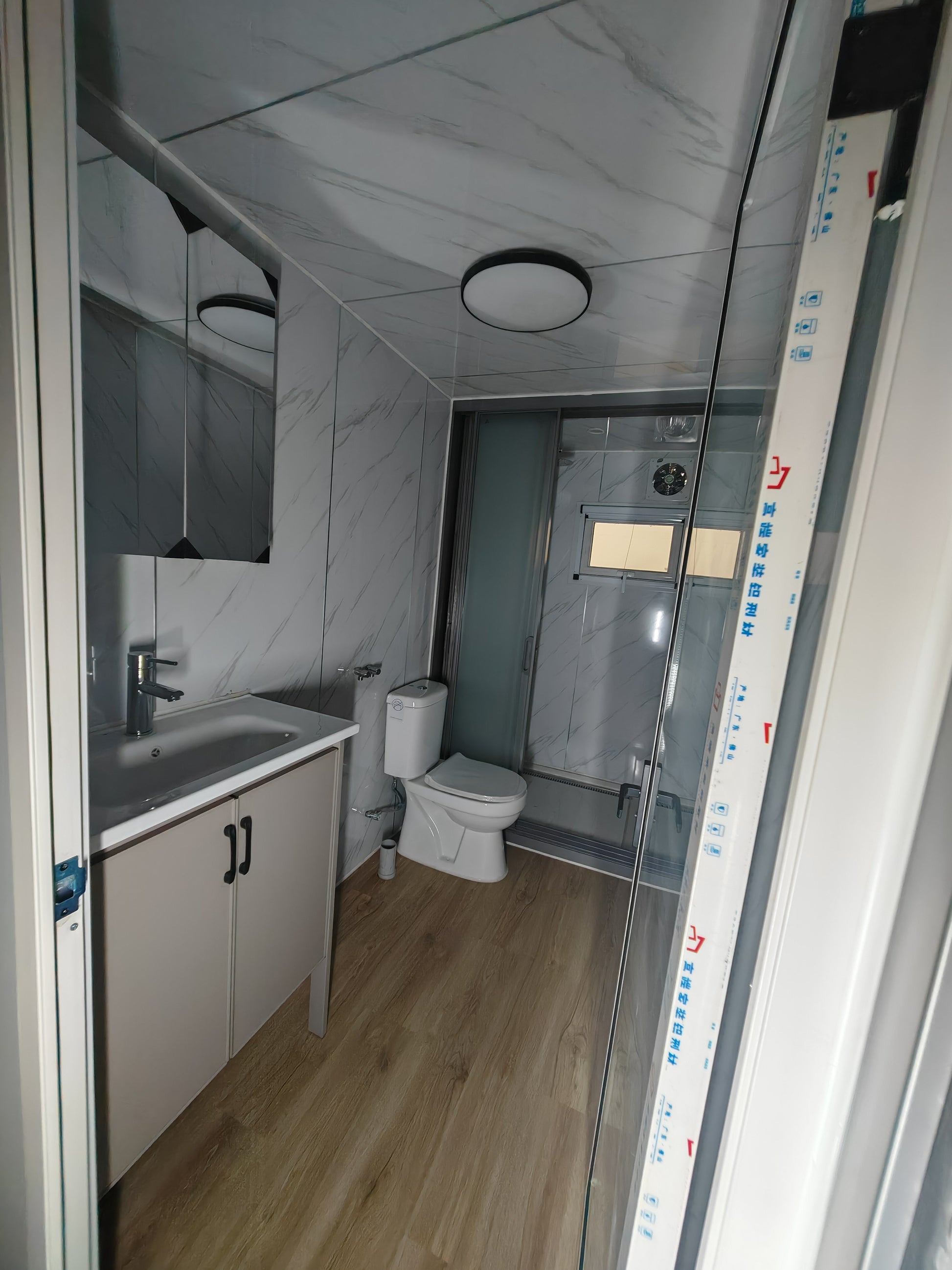 Bathroom interior with sink, toilet, and shower area.