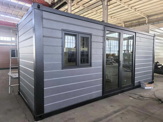 Studio with gray exterior and large windows in an indoor setting