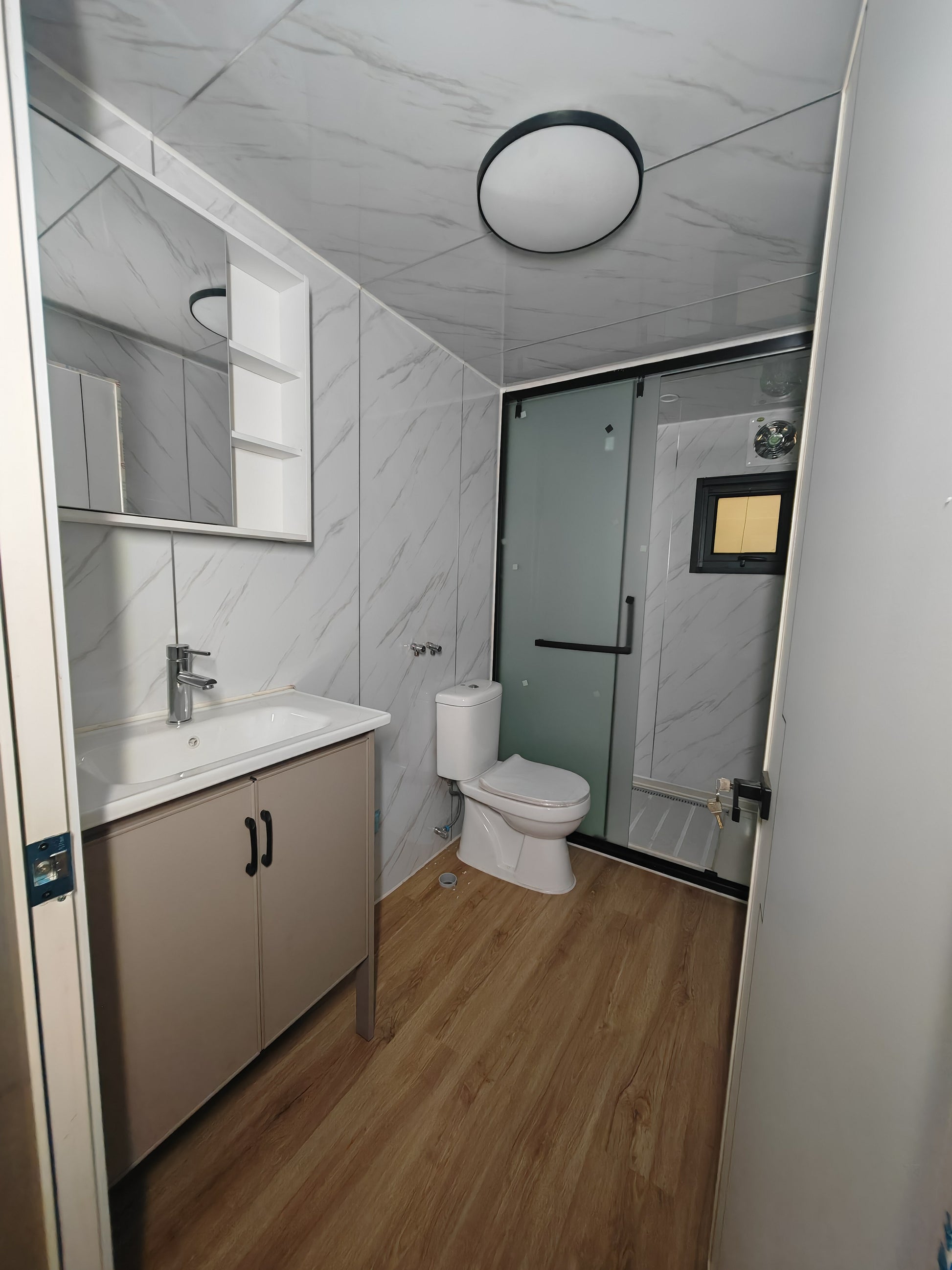 Bathroom with vanity, toilet, and shower stall
