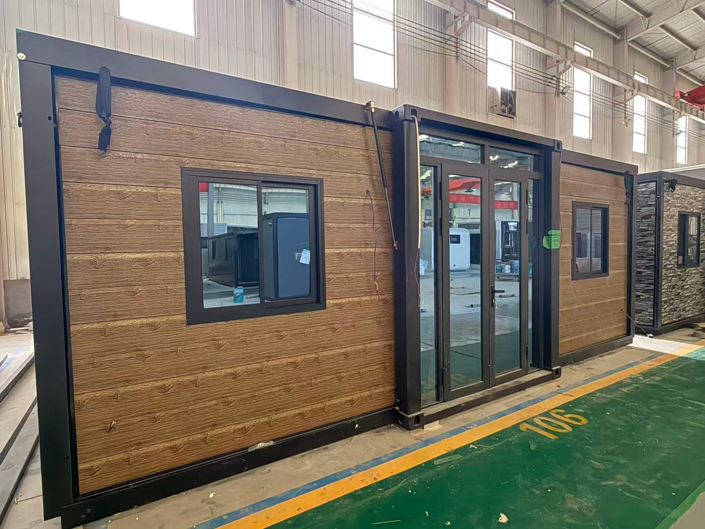 Modular  cabin with wooden  exterior and black trim 
