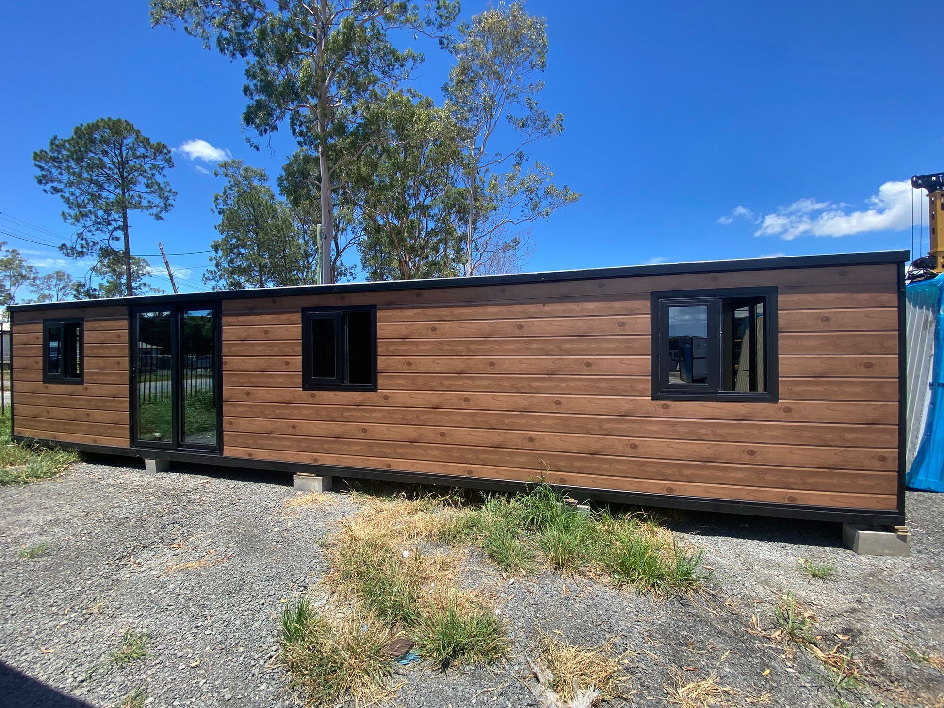 Modular building with wooden exterior and black window frames