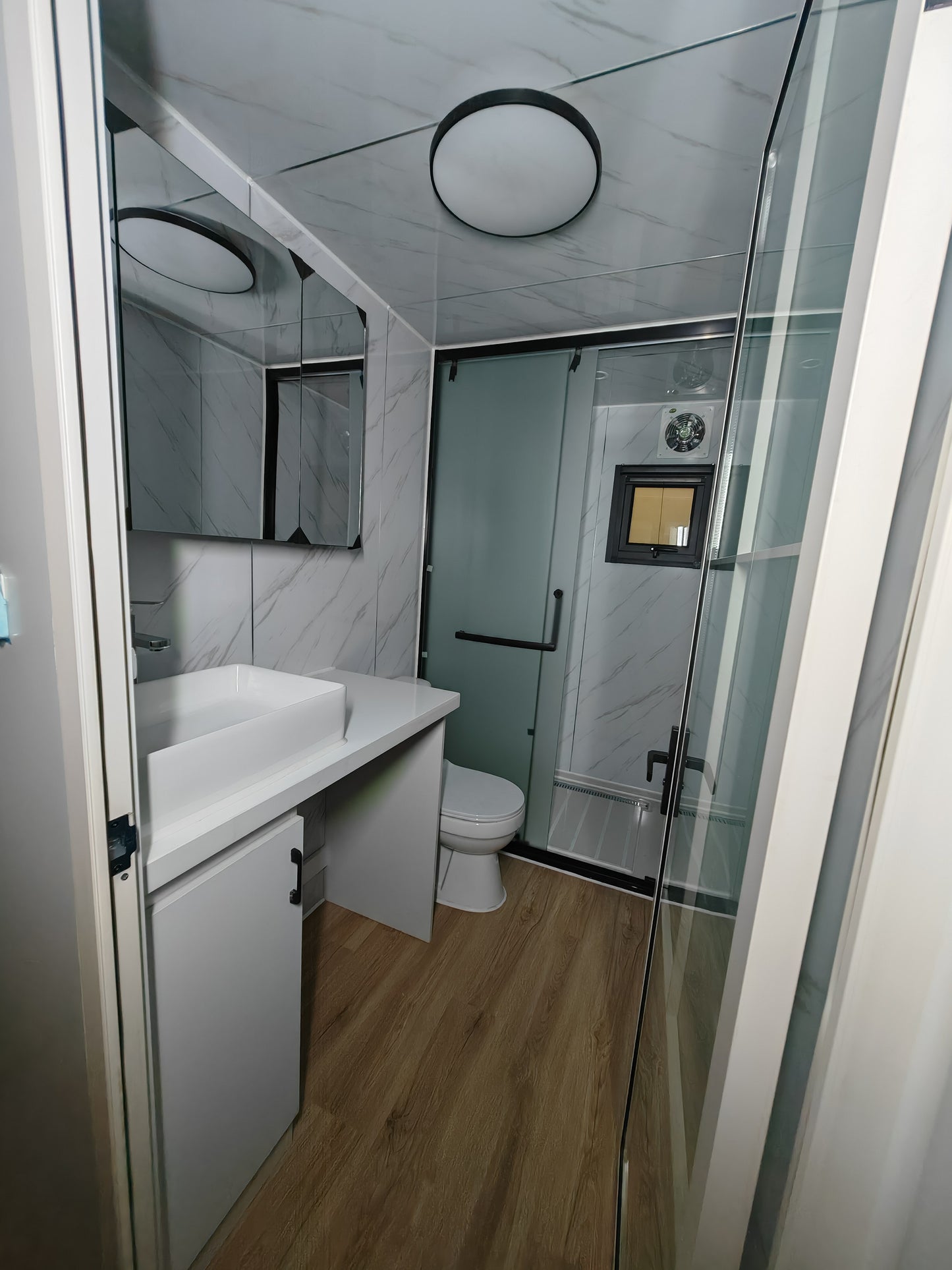 Bathroom interior with shower, sink, and toilet