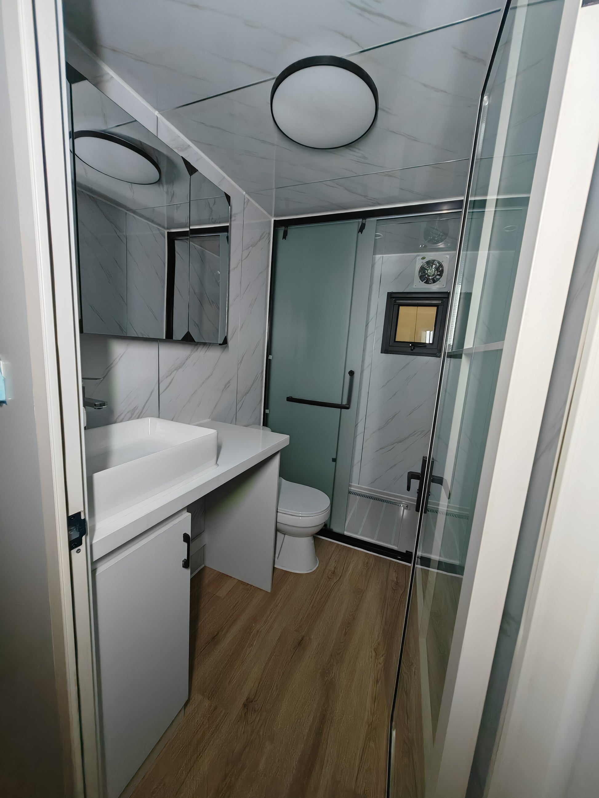 Bathroom interior with shower, sink, and toilet