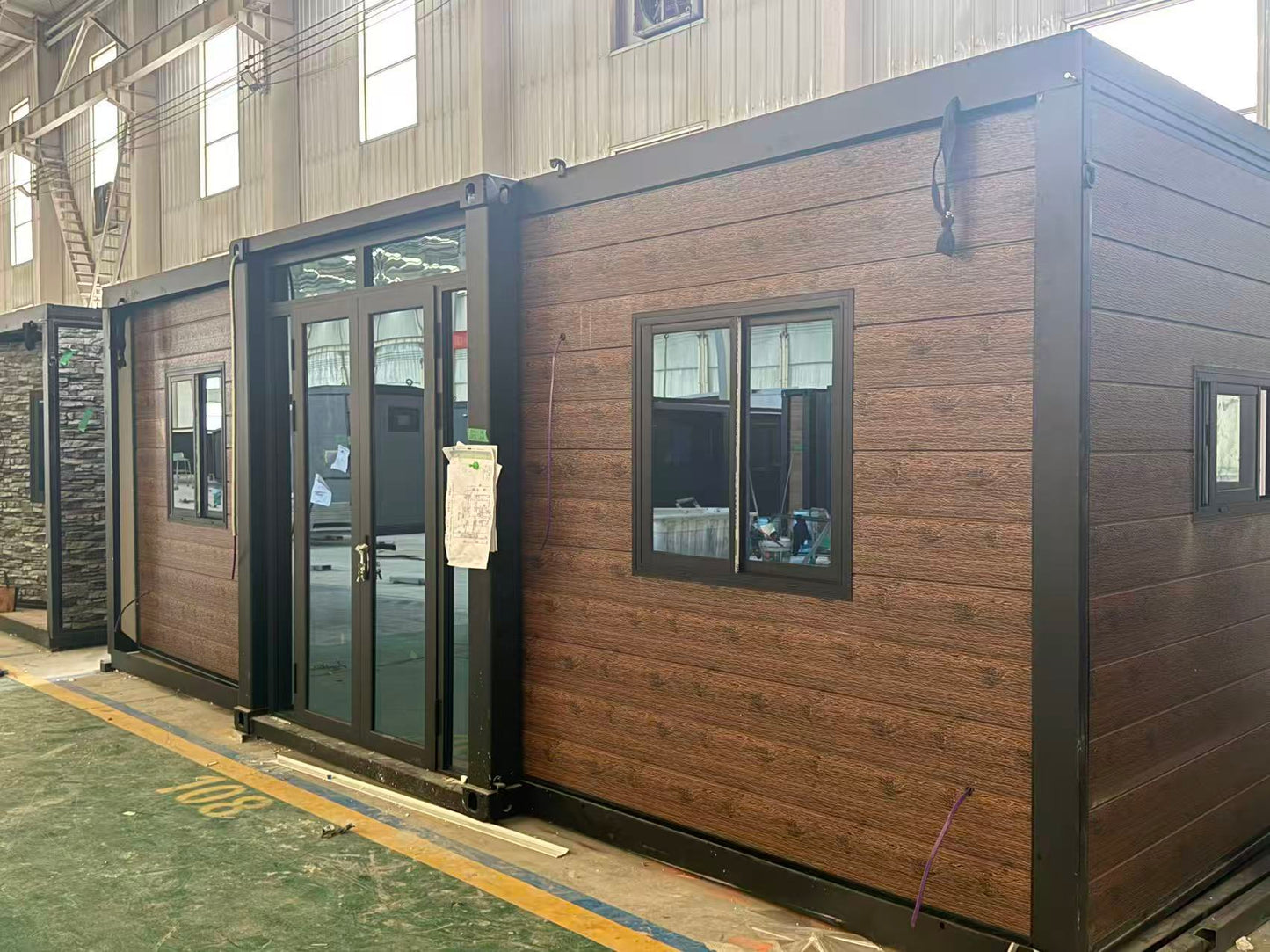 Flat expandable home model FE40 with timber look cladding