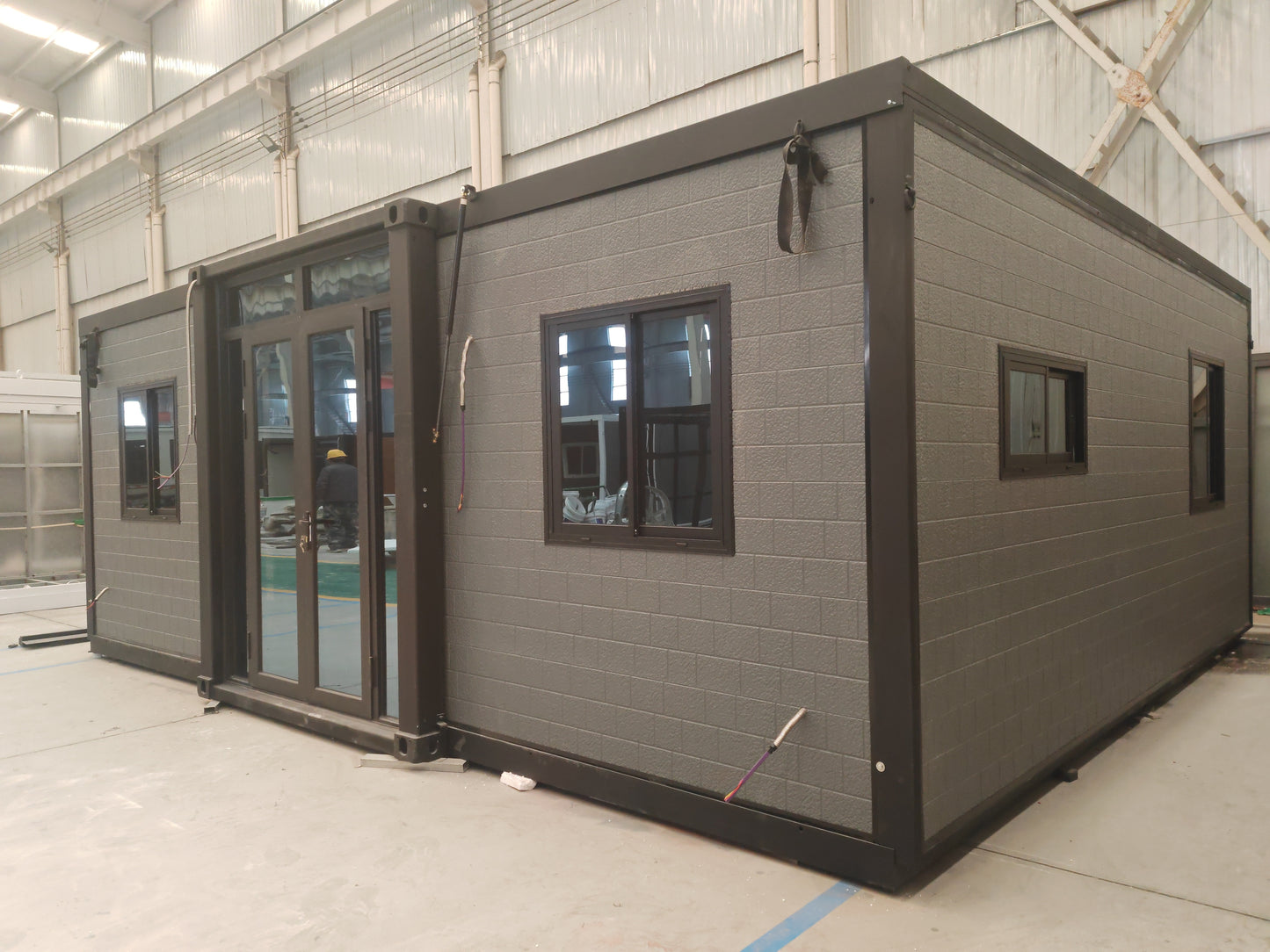 Modular  cabin with gray exterior and black trim 