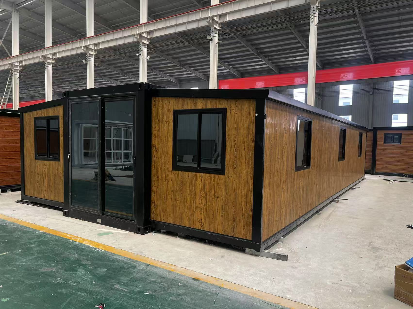 40ft modular wooden cabins in a warehouse setting