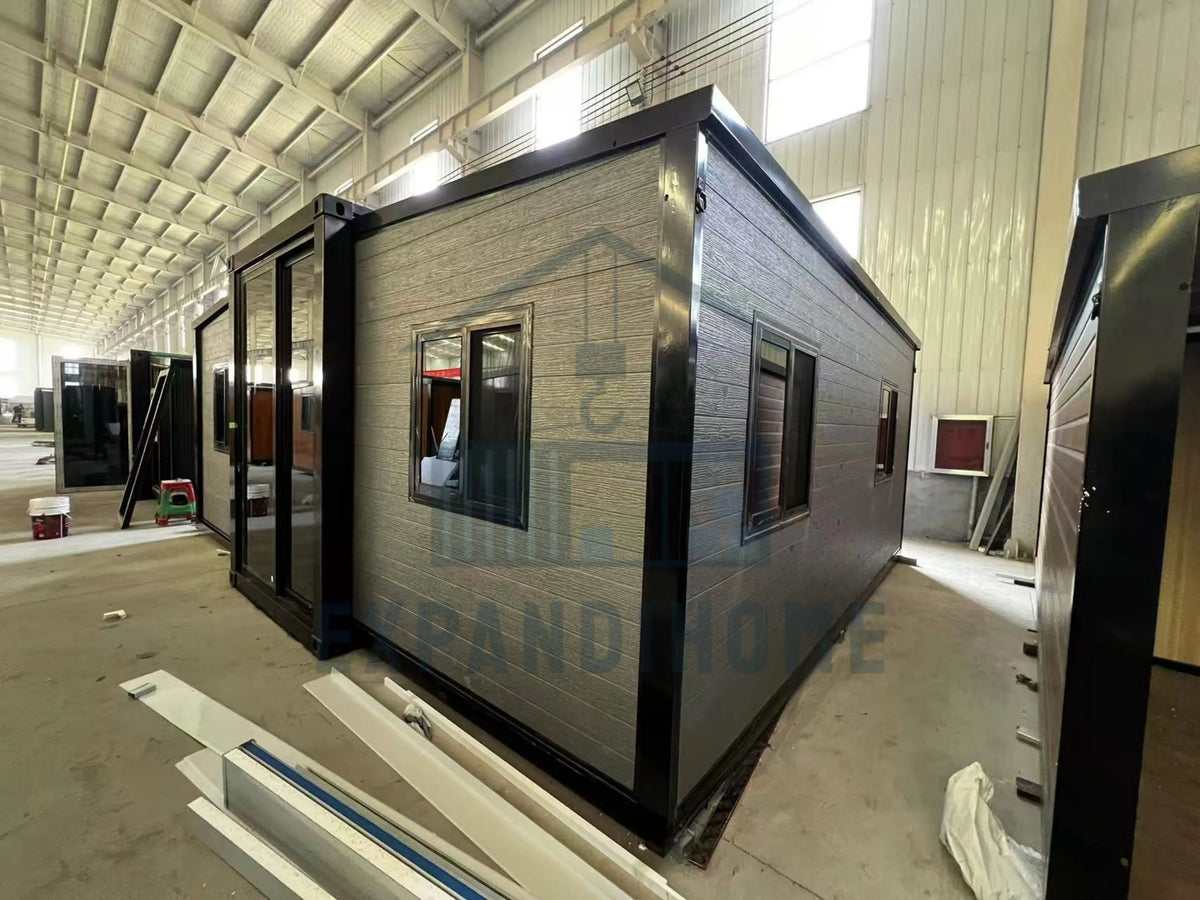 Modular building components in a warehouse setting with branding visible.