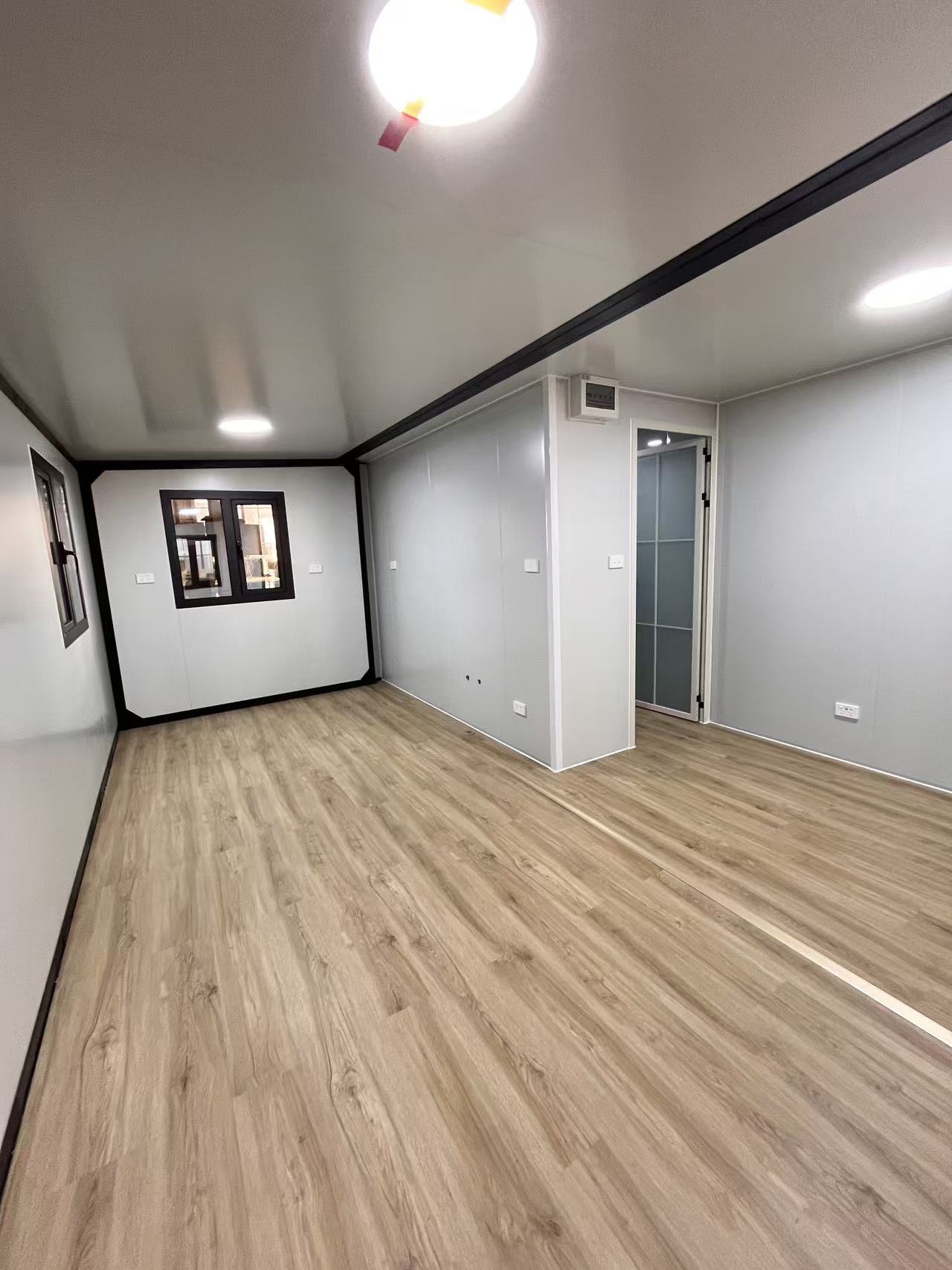 Empty room with wooden flooring and white walls