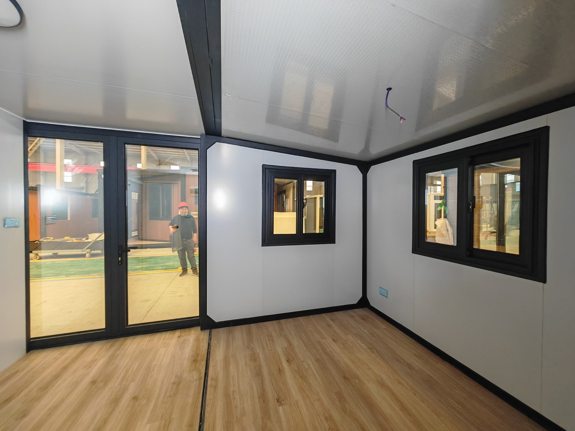 Modern office pod with glass walls and ceiling lights