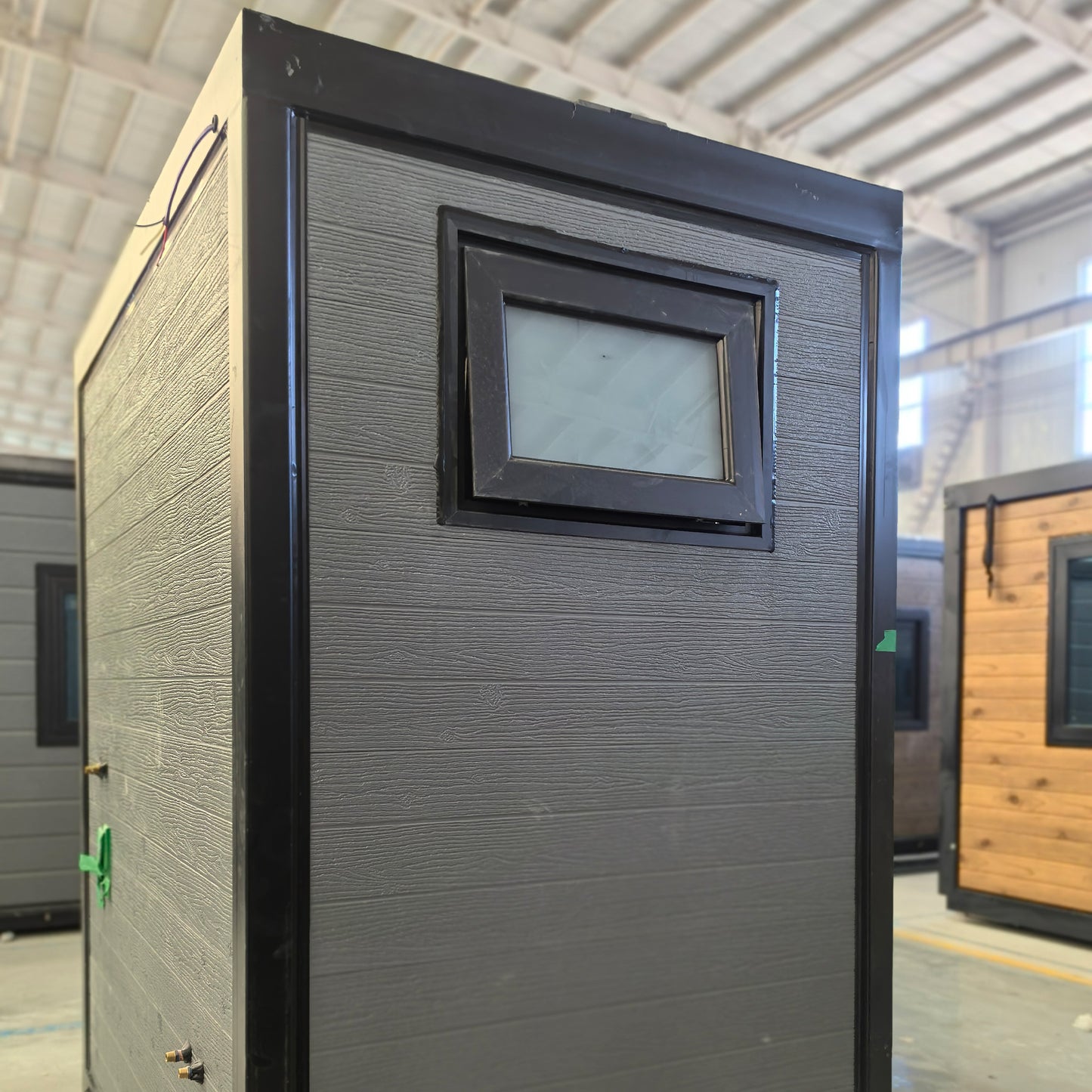Black-framed door with a small window in a bathroom